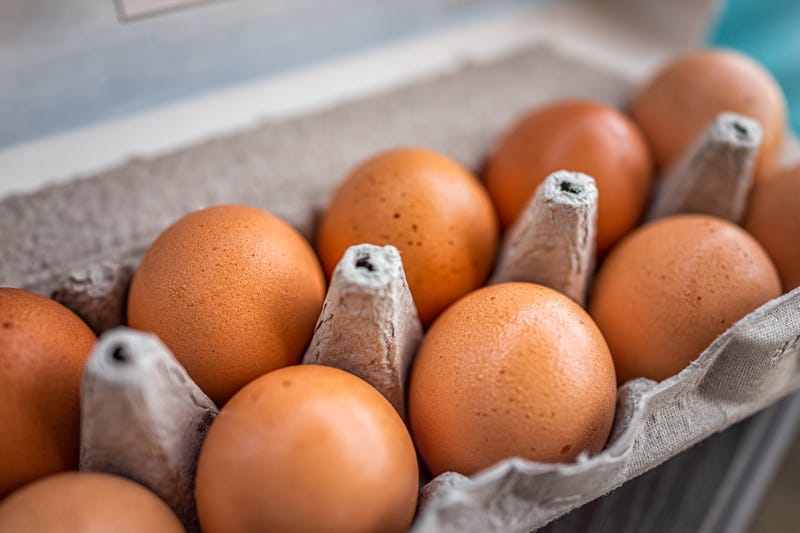A close up of eggs in a carton. 