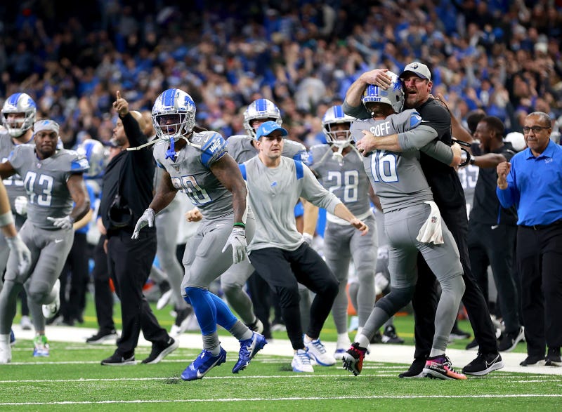 The Detroit Lions celebrate their first win of the season.