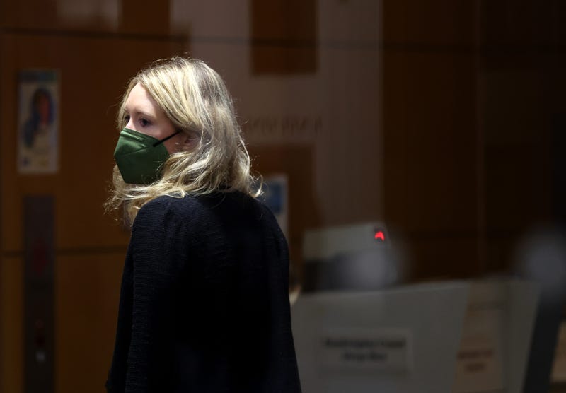 Theranos founder and former CEO Elizabeth Holmes pauses while going through a security checkpoint as she arrives for trial at the Robert F. Peckham Federal Building on December 07, 2021 in San Jose, California. 