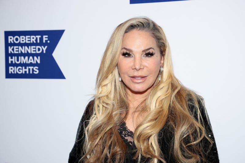 Adrienne Maloof faces camera against Robert F Kennedy Human Rights printed backdrop
