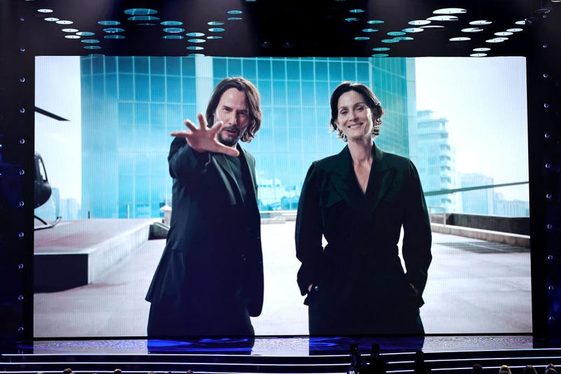 (L-R) Keanu Reeves and Carrie-Anne Moss speak onscreen during The Game Awards 2021 at Microsoft Theater on December 09, 2021 in Los Angeles, California. 