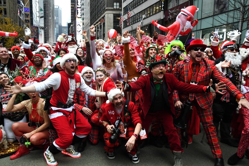 People dressed in Santa Claus costumes participate in SantaCon on December 11, 2021 in New York City.