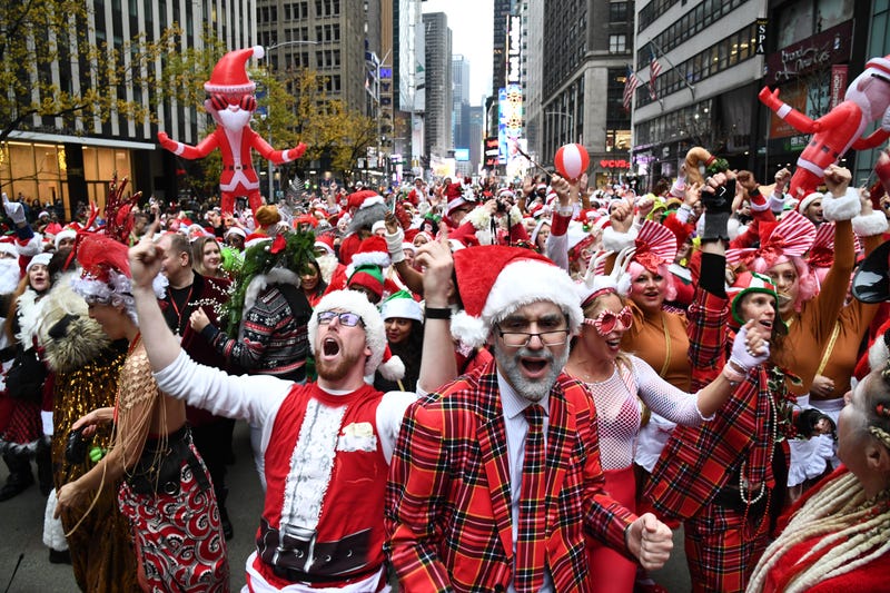 People dressed in Santa Claus costumes participate in SantaCon in Manhattan