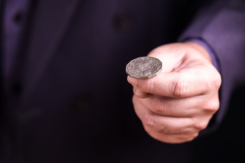 Man preparing to flip a coin