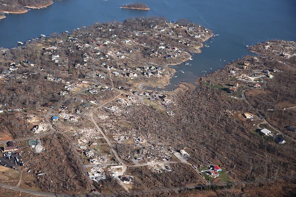 An aerial view, homes and surrounding area are heavily damaged after they were hit by a tornado three days prior.