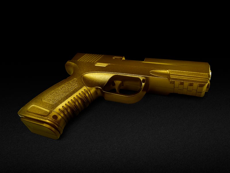 gun gold metal isolated on black background