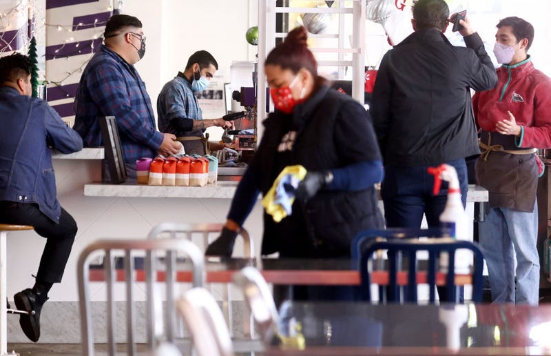 FILE - People wear face coverings inside Grand Central Market on Dec. 15, 2021 in Los Angeles.