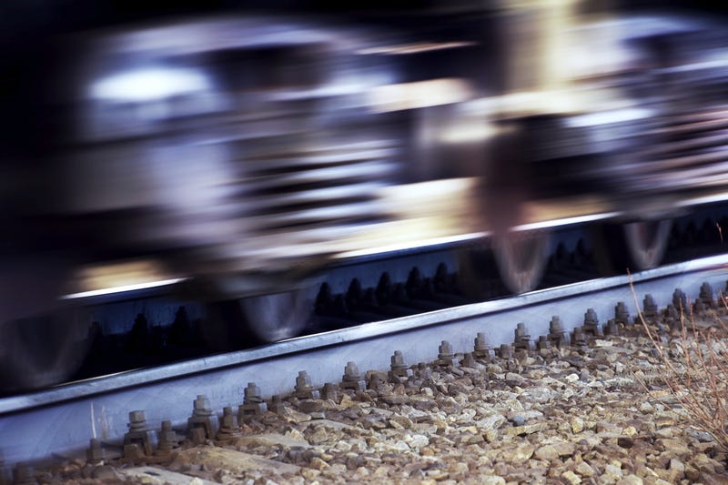 Wheels and springs of a train rushing along the rails