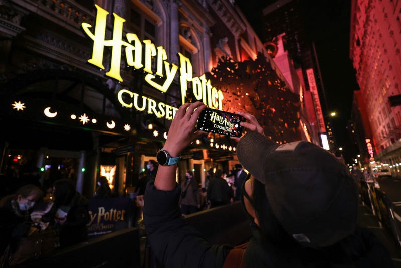 6: A passerby takes a photo of the "Harry Potter and the Cursed Child" marquee at the Lyric Theatre before the evening show on December 16, 2021 in New York City. 