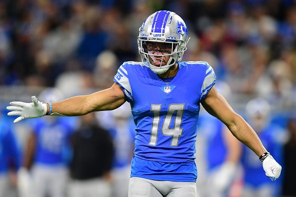 Amon-Ra St. Brown models the Lions Honolulu Blue uniforms. 