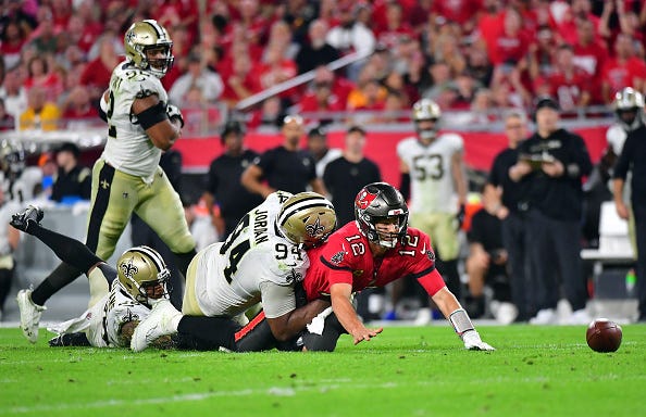 The New Orleans Saints tackle and force Tom Brady to fumble
