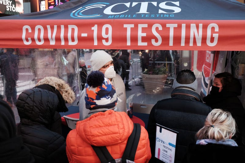 People wait in long lines in Times Square to get tested for Covid-19 on December 20, 2021 in New York City.