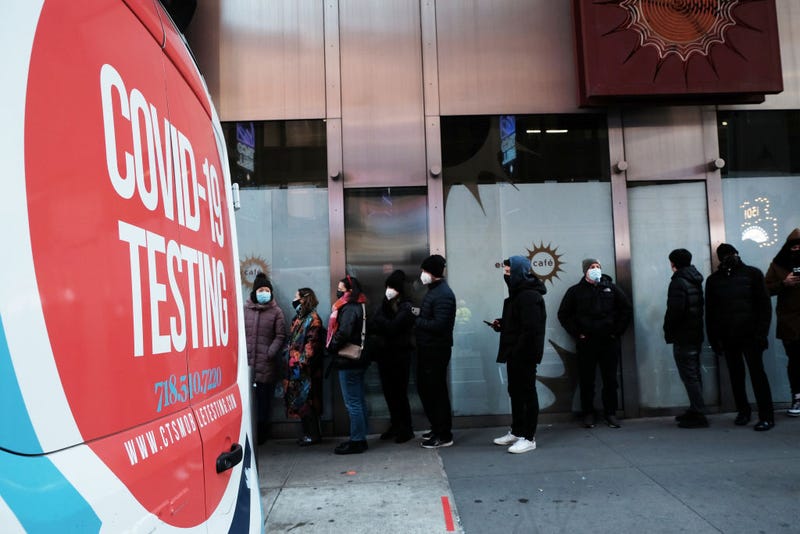People wait in long lines in Times Square to get tested for COVID-19 on Dec. 20, 2021, in New York City.