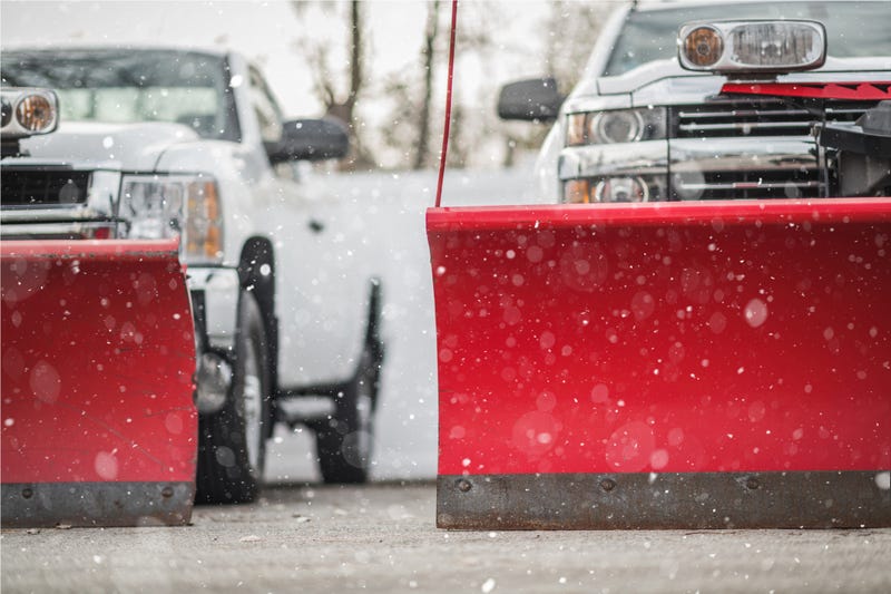 Stock photo of pickup trucks with red snow plows