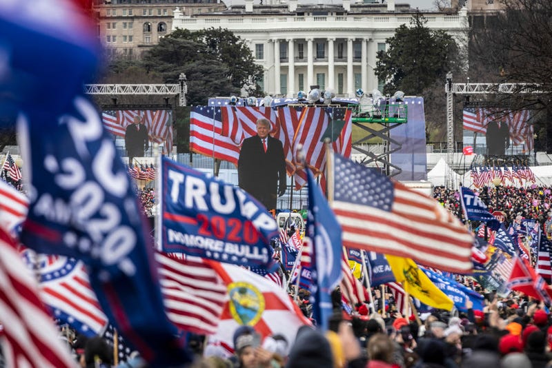 U.S. President Donald Trump is seen on a screen as his supporters cheer during a rally on the National Mall on January 6, 2021 in Washington, DC. Trump supporters gathered in the nation's capital today to protest the ratification of President-elect Joe Biden's Electoral College victory over President Trump in the 2020 election. (Photo by Samuel Corum/Photo by Samuel Corum/Getty Images)