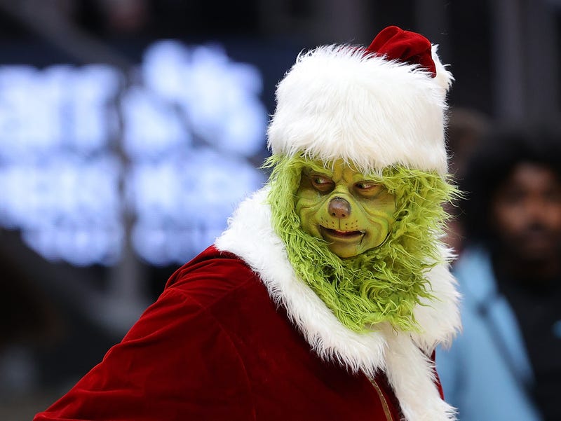 The Grinch character is seen tossing out shirts during the first half between the Atlanta Hawks and the Orlando Magic at State Farm Arena on December 22, 2021 in Atlanta, Georgia. NOTE TO USER: User expressly acknowledges and agrees that, by downloading and or using this photograph, User is consenting to the terms and conditions of the Getty Images License Agreement. (Photo by Kevin C. Cox/Getty Images)