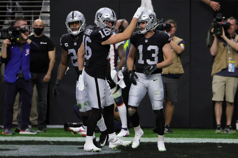 Hunter Renfrow #13 of the Las Vegas Raiders is congratulated by Dillon Stoner #16 after Renfrow caught a touchdown pass against the Denver Broncos