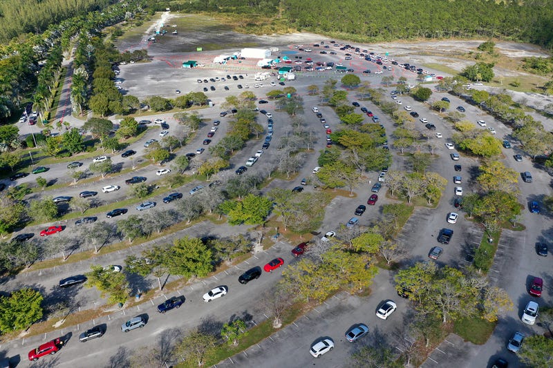 In an aerial view, cars line up at a drive-thru COVID-19 testing site at the Zoo Miami site on December 29, 2021 in Miami, Florida