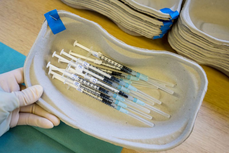 Tagreed Husain, Employee of the German Red Cross, prepares syringes with Moderna vaccine against Covid-19 in a mobile vaccination station in a street tram during the novel coronavirus pandemic on December 30, 2021 in Frankfurt, Germany. 