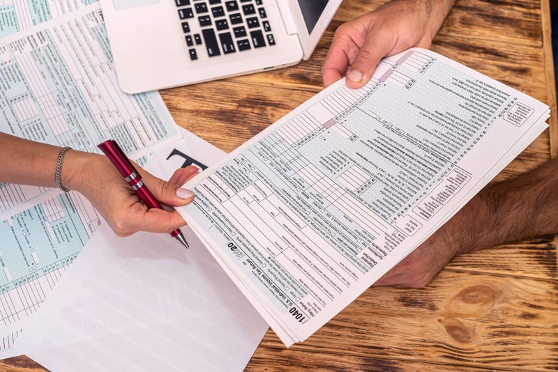 People holding tax forms.