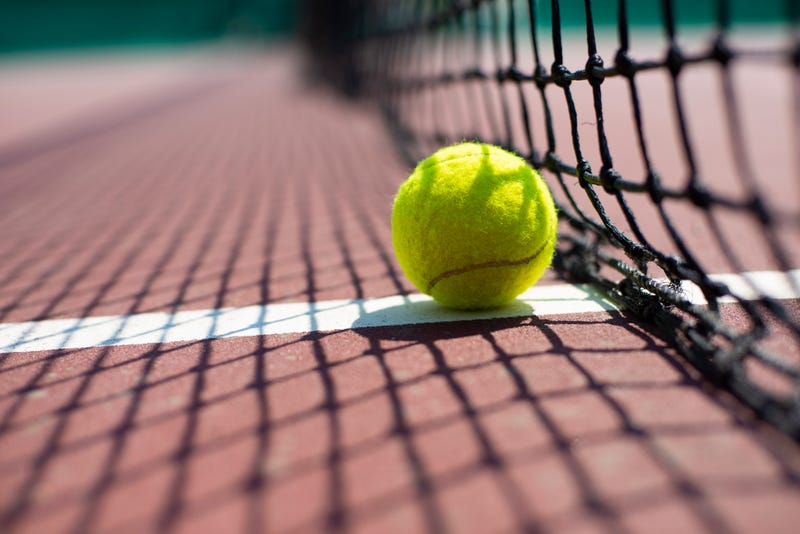 Tennis ball lying on the court