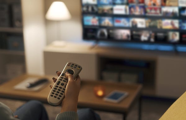 Woman watching video on demand on her TV