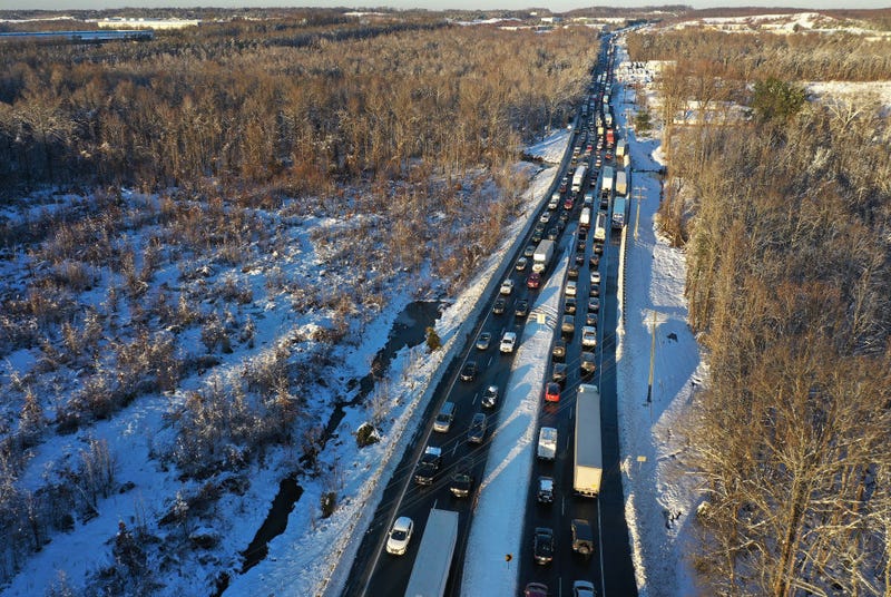 In an aerial view, traffic creeps along Virginia Highway 1 after being diverted away from I-95 after it was closed due to a winter storm on January 04, 2022 near Fredericksburg in Stafford County, Virginia. A winter storm with record snowfall slammed into the Mid-Atlantic states, stranding thousands of motorists overnight on 50 miles of I-95 in Virginia. (Photo by Chip Somodevilla/Getty Images)