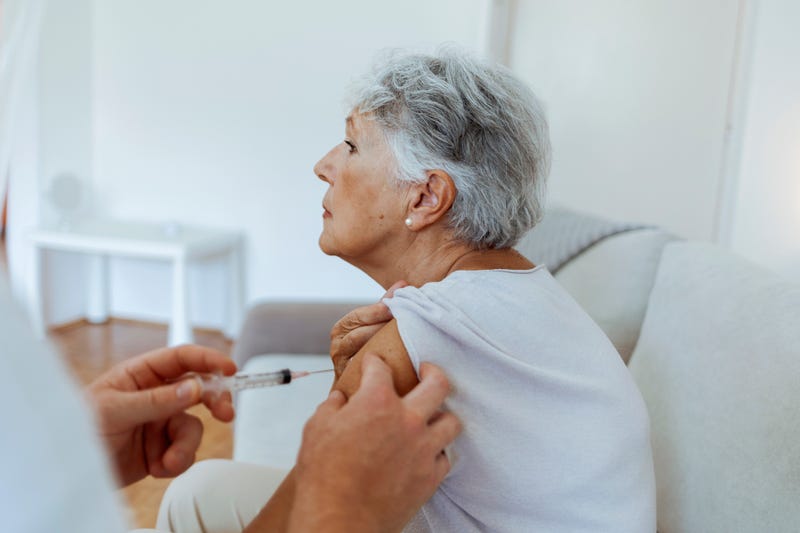 Senior woman getting vaccine stock photo. 