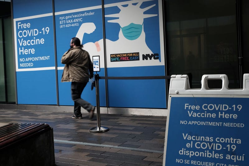 People walk by a Covid-19 vaccination site at a mall near the Staten Island Ferry Terminal on January 05, 2022 in New York City.