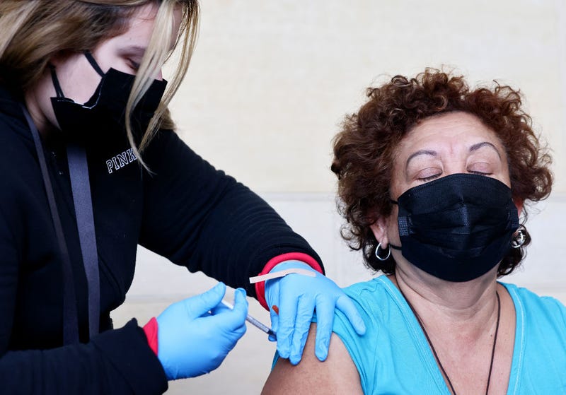 A person receives a COVID-19 vaccination dose, during a free distribution of COVID-19 rapid test kits for those who received vaccination shots or booster shots, at Union Station on January 7, 2022 in Los Angeles, California.