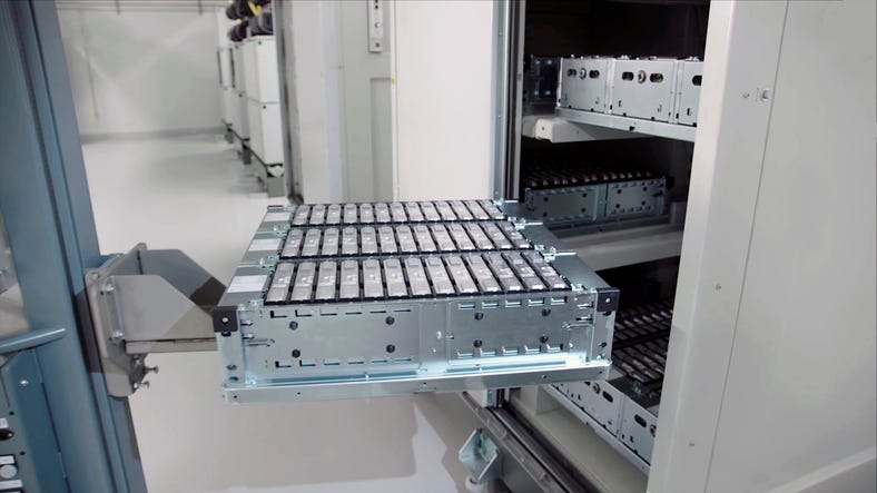close-up of an electric car battery on top of a forklift truck going into a cabinet in an electric car battery factory.