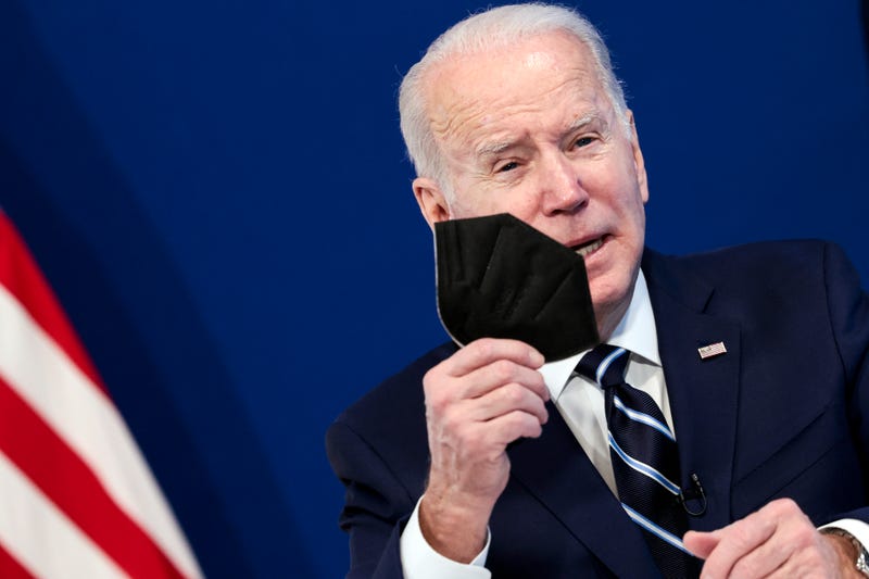 U.S. President Joe Biden holds a mask as he gives remarks on his administration's response to the surge in COVID-19 cases across the country