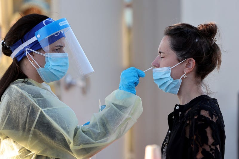 Jordane Domain gets a COVID-19 test done by a healthcare worker on January 13, 2022 in North Miami, Florida.