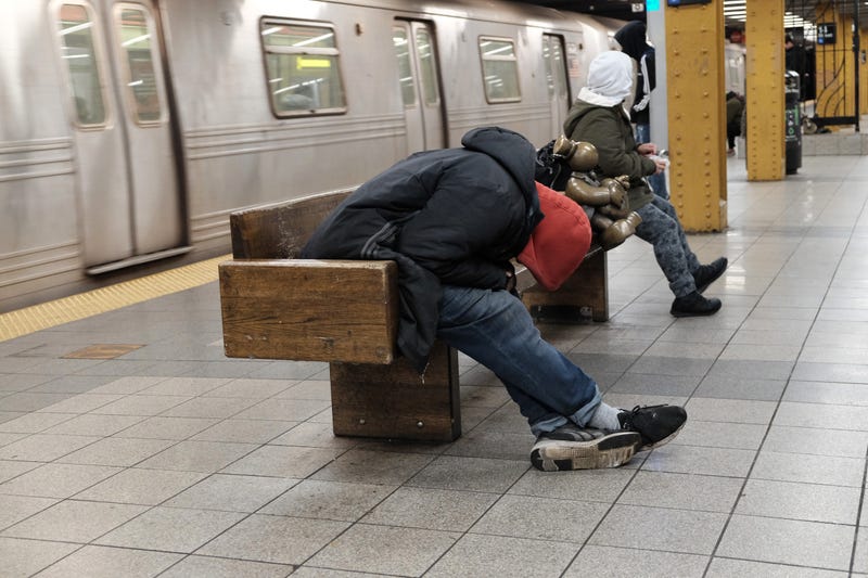 A man sleeps on a subway platform in Manhattan on January 19, 2022 in New York City