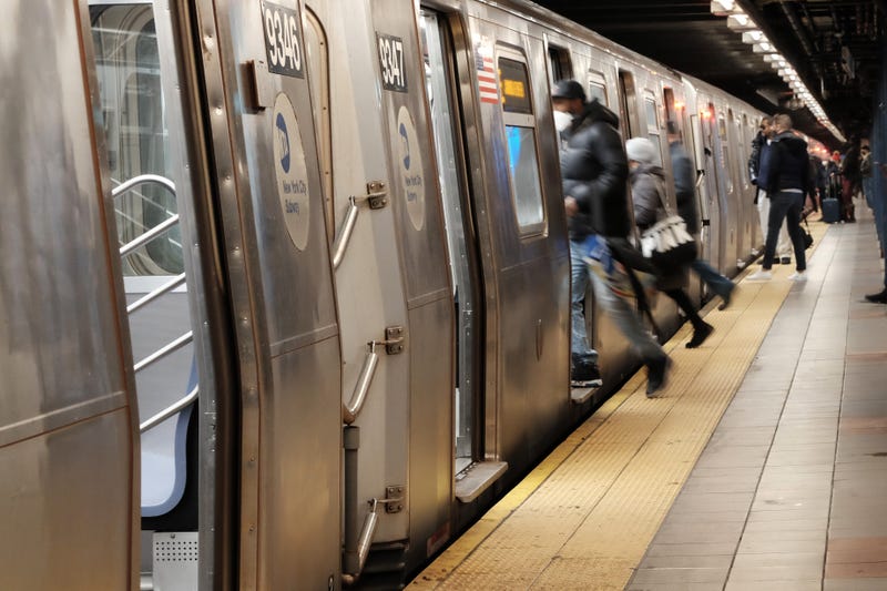 People board a subway on January 19, 2022 in New York City