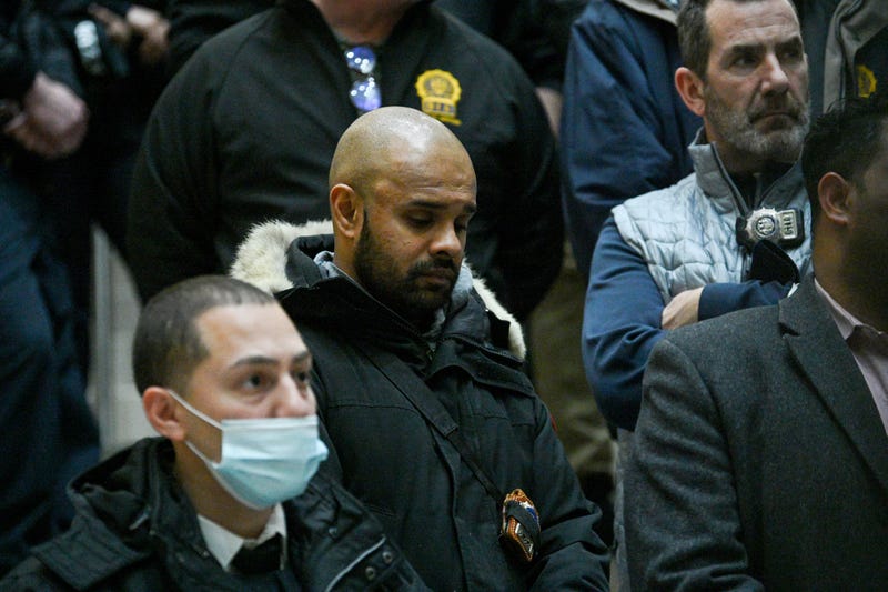 1: Members of the NYPD gather on the staircase during a press conference at Harlem Hospital on January 21, 2022 in New York City.