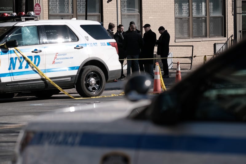 Police gather at the scene in Harlem where two NYPD officers were shot while responding to a domestic call on Jan. 22, 2022
