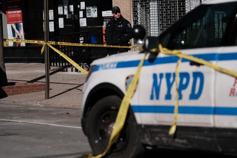 Police gather at the scene in Harlem where two New York City police officers were shot last night after responding to a domestic call on January 22, 2022 in New York City.
