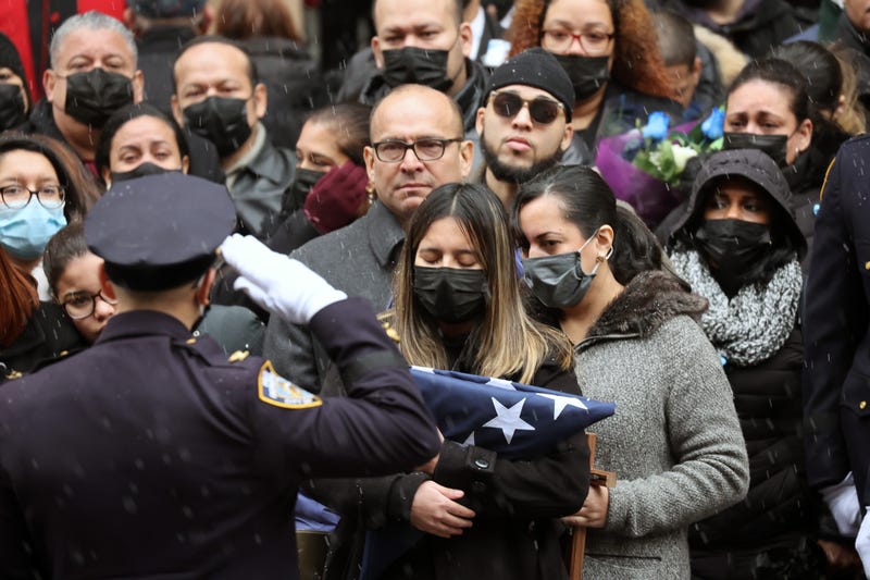 Dominique Rivera, the wife of fallen NYPD Officer Jason Rivera, holds a flag from his casket during his funeral at St. Patrick's Cathedral on Jan. 28, 2022