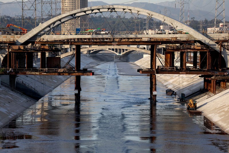 FILE - The Los Angeles River flows beneath the Sixth Street Viaduct replacement project on Feb. 3, 2022 in Los Angeles. As climate change makes droughts more frequent and severe, concerns are growing among environmentalists that the 51-mile Los Angeles River could dry up. On most days of the year, 90% of the water flowing in the river has been discharged from wastewater treatment plants. Some cities along the river are aiming to increase wastewater recycling which would deprive the river of much of its water and threaten the river habitat.
