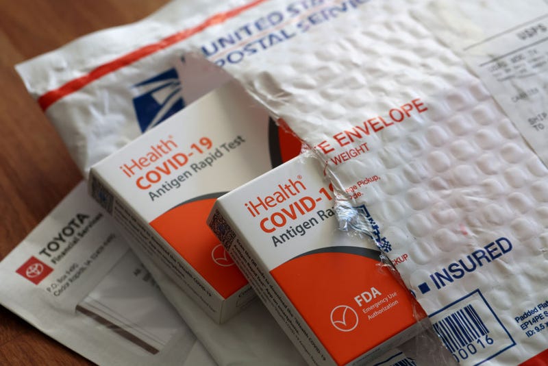  free iHealth COVID-19 antigen rapid tests from the federal government sit on a U.S. Postal Service envelope after being delivered on February 04, 2022 in San Anselmo, California. 