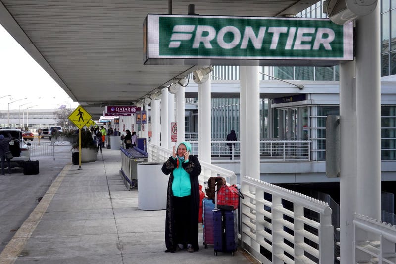 Passengers arrive for flights on Frontier Airlines at O'Hare International Airport on February 07, 2022 in Chicago, Illinois. Frontier has announced a merger with Spirit Airlines, creating what will become the fifth-largest airline in the United States. (Photo by Scott Olson/Getty Images)