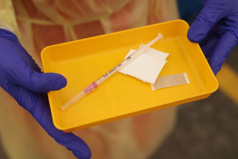 A medical worker holds a syringe of the Moderna vaccine against Covid-19 at a newly-opened drive-in vaccination center during the Omicron wave of the novel coronavirus pandemic on February 10, 2022 in Berlin, Germany.