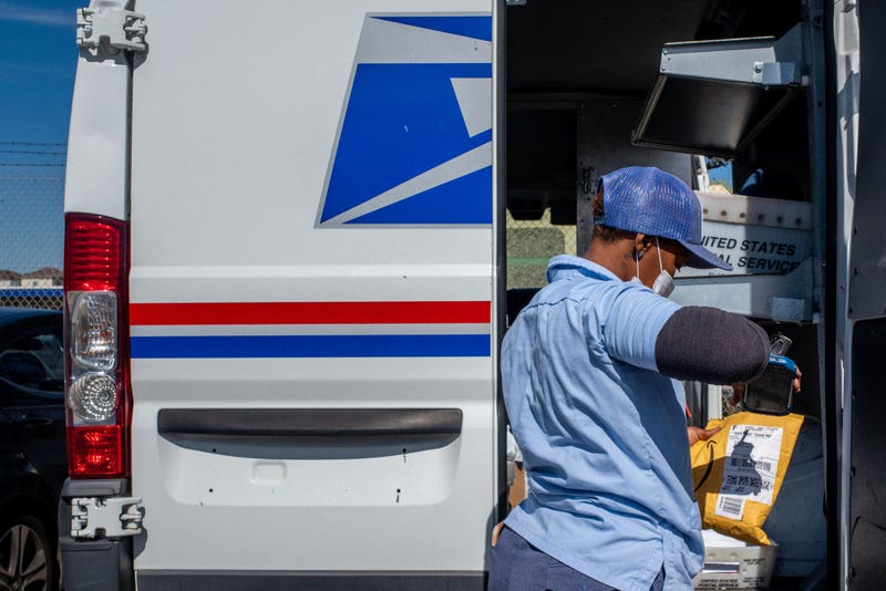 A US Postal service employee scans a package on February 10, 2022 in Houston, Texas. On February 8, the House of Representatives passed the Postal Service Reform Act of 2022 (H.R. 3076). The legislation will address operational and financial issues that the agency has been grappling with for years. (Photo by Brandon Bell/Getty Images)