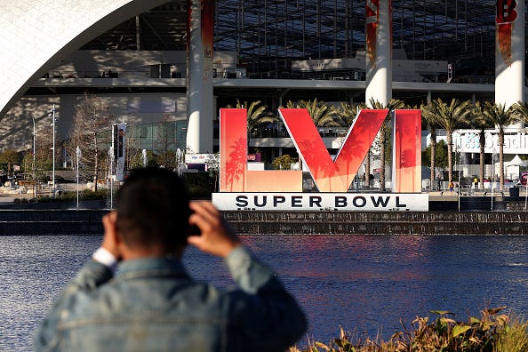 A man takes a photo of SoFi Stadium ahead of Super Bowl LVI.