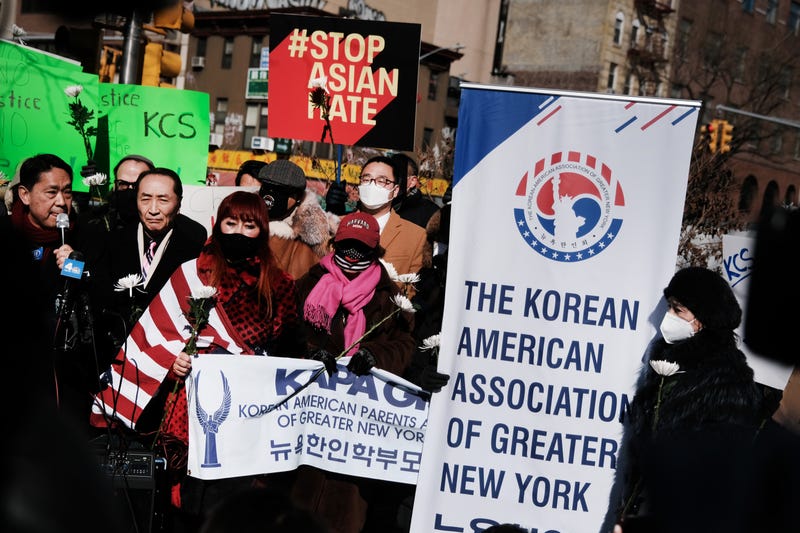 A man holds a flower as members of the Korean American Association and others hold a rally in Manhattan's Chinatown on Feb. 15, 2022. Anti-Asian hate crimes have surged during the pandemic