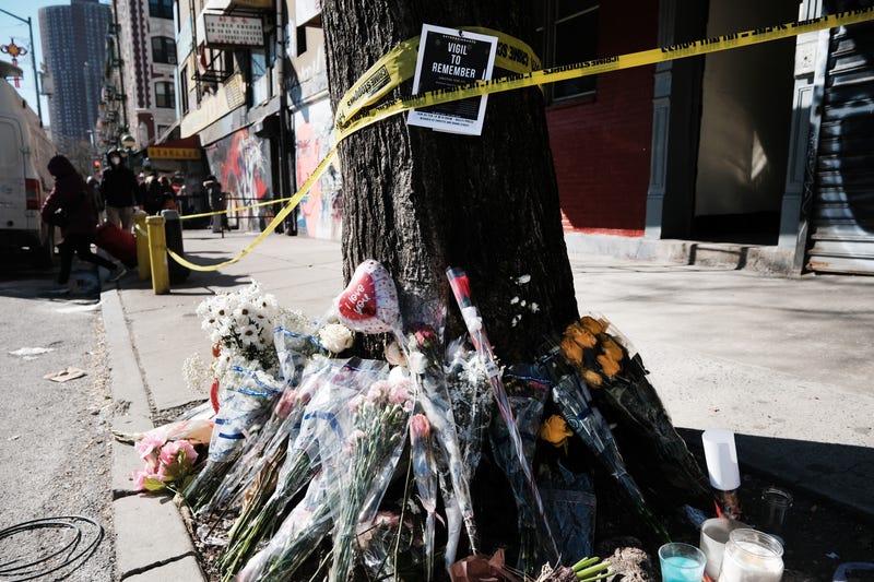 The makeshift memorial outside Christina Yuna Lee's apartment before it was vandalized