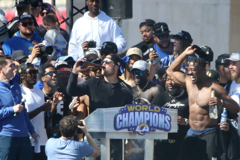 Matthew Stafford (L, Center) of the Los Angeles Rams celebrates on stage during the Super Bowl LVI Victory Parade on February 16, 2022 in Los Angeles, California.
