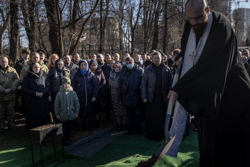 Friends and family watch on as Captain Anton Olegovich Sidorov is laid to rest during his funeral ceremony on February 22, 2022 in Kyiv, Ukraine
