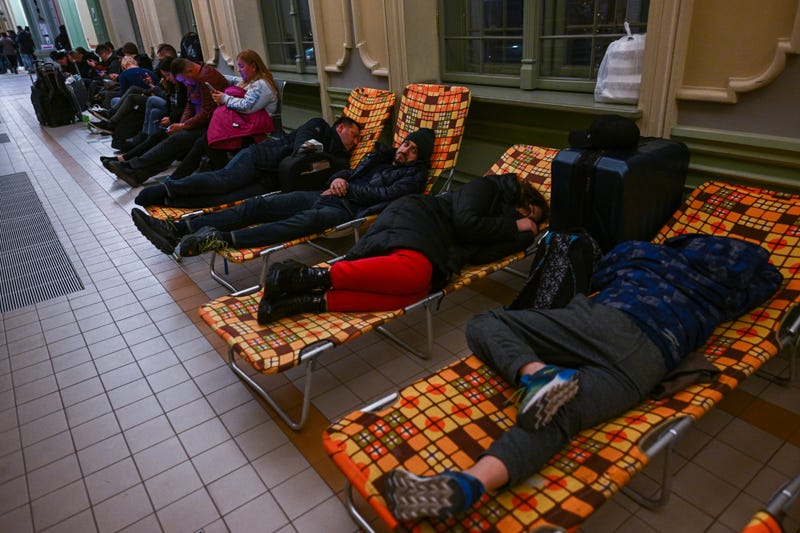Ukrainian citizens rest overnight in a temporary shelter after arriving in a train from Kiev at Przemysl main train station on February 24, 2022 in Przemysl, Poland
